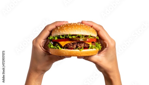 Hands holding a juicy burger