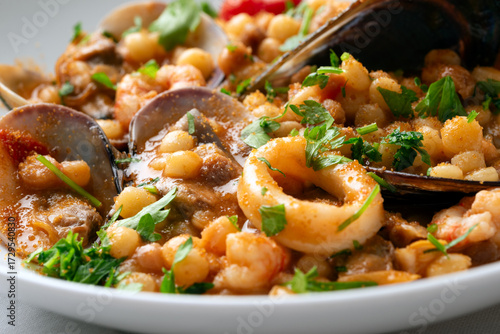 Bild auf Leinwand Fregula con frutti di maree bottarga, ricetta tipica della Cucina Sarda di mare,