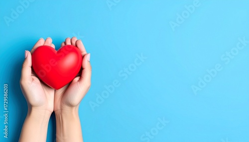 Two hands gently cup a glossy red heart against a vibrant light blue background, symbolizing love, care, and health. Generated image