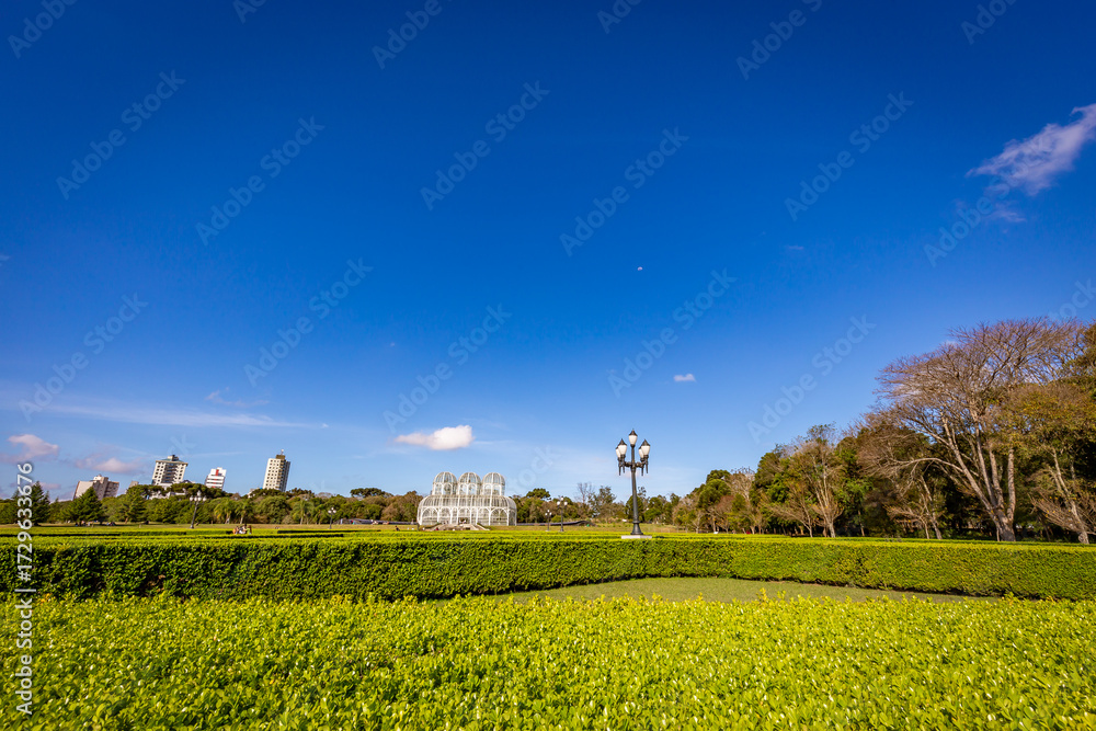 Obraz premium Botanical Garden of Curitiba on a sunny day with blue sky and lush tropical vegetation