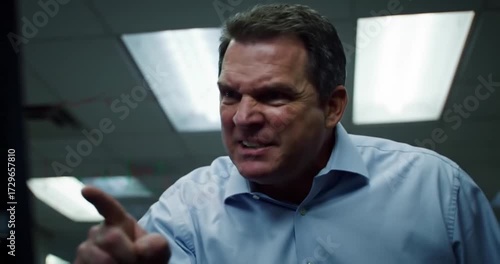 Angry man pointing in office during heated discussion