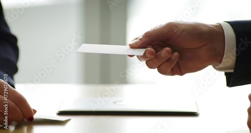 Business professionals exchanging contact information indoors