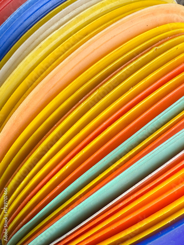 A stack of colorful plastic plates with a rainbow pattern