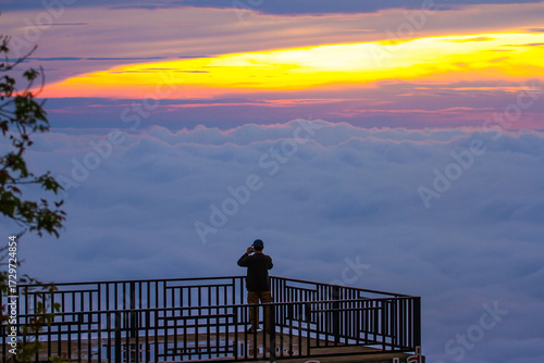 silhouette of a man standing on terrace with sea of mist