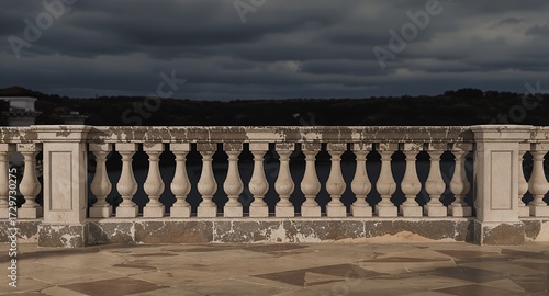 A stone balustrade overlooking a dark, moody landscape, weathered and aged.