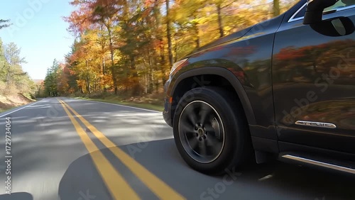 Wallpaper Mural Extreme Close-Up Shot of Vehicle's Rotating Rubber Tire Moving Along Painted Pavement Marking on Wooded Pathway Torontodigital.ca