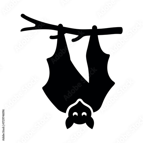 Silhouette of a cute bat hanging upside down from a tree branch