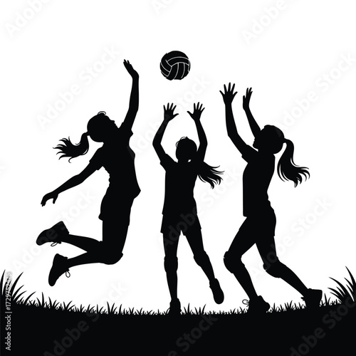 Three Female Volleyball Players About to Strike the Volleyball