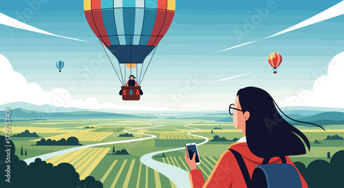 Woman looking at a hot air balloon ride over a vast landscape.