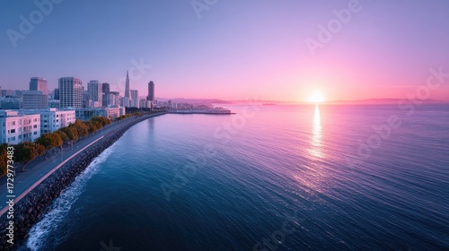 Wallpaper Mural Sunrise Over the City Skyline and Ocean with Pink and Blue Hues Calm Water Reflecting Sunlight at Coastal Urban Landscape with Modern Buildings Torontodigital.ca