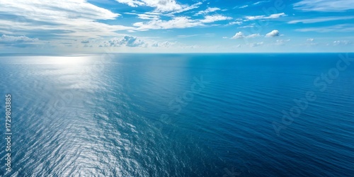 Wallpaper Mural Vast expanse of the deep blue ocean under a bright sunny sky with scattered clouds. Torontodigital.ca