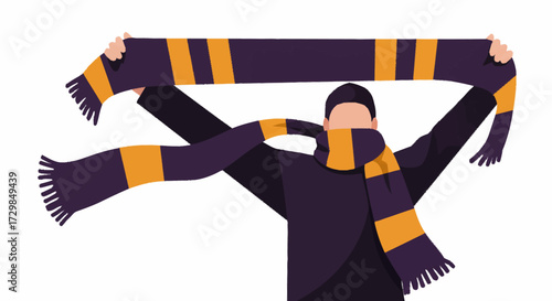 A person holds up a striped scarf with tassels, displaying team colors and showing support.