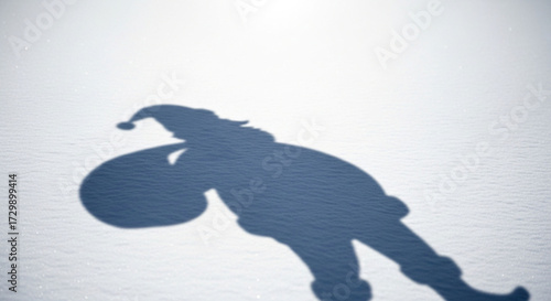 The shadow of santa claus carrying a bag of gifts is projected onto the snow, creating a whimsical and festive scene, isolated on white background