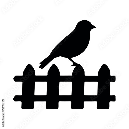 Silhouette of a small bird perched atop a rustic wooden picket fence
