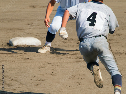 Fototapeta 高校野球の試合で懸命に2塁へ向かう選手とタッチの準備をする選手