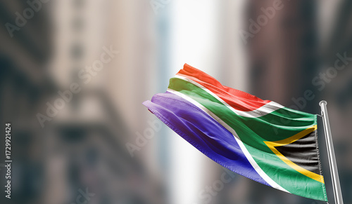 South Africa national flag waving on street. A beautiful with mast with blur buildings. South Africa national flag for independence day.