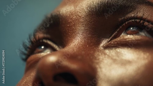 A Gaze of Hope and Aspiration: Close-up view of expressive eyes, gazing upward with hope and anticipation, bathed in soft, natural light.