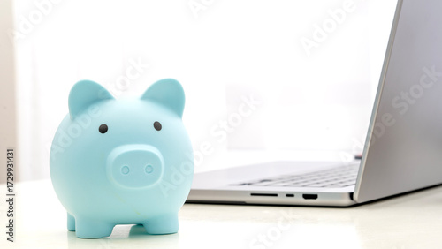Piggy bank piggy bank on the table by the laptop