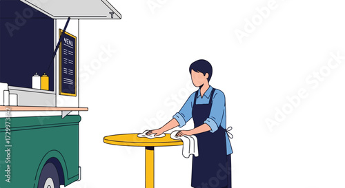 Maintaining hygiene at a food truck: Worker wiping a table ensuring cleanliness for customers and a sanitary environment showcasing dedication to