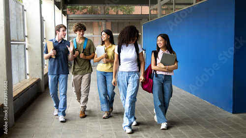Quadro su tela Happy students walking and talking at school corridor