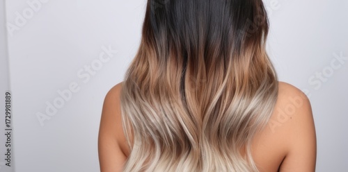 Rear View of Woman with Wavy Gradient Hair on Light Background