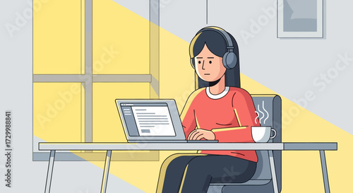 A woman wearing headphones works on a laptop at a desk, near a window.