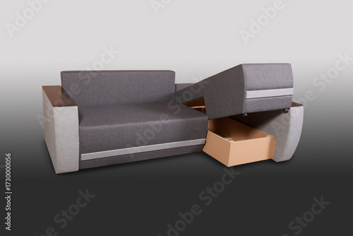 Isolated sofa bed with fabric upholstery on grey gradient background.