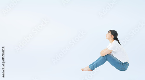 座って上を見上げるカジュアルウェアを着た10代女性の切り抜き全身写真（切り抜き背景透過PNGも販売しております。↓作成者リンクから「PNG」で検索してください）