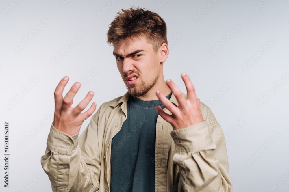 Fototapeta premium Young man expressing frustration with hands raised
