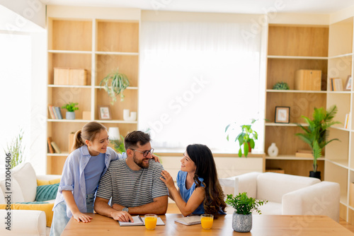Photos Family bonding over creative activities in a bright, cozy living room