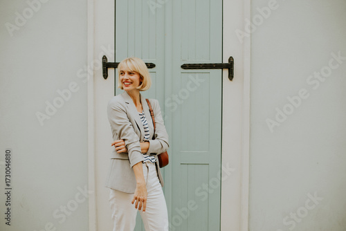 Stylish woman poses with co...