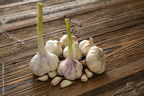 Garlic cloves stylised on weathered wooden boards