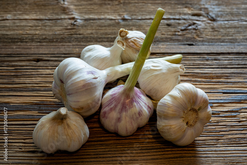 Garlic cloves stylised on weathered wooden boards