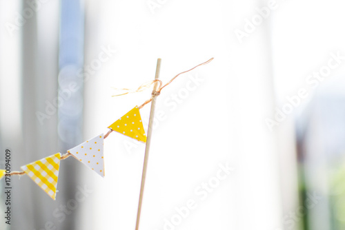 decorative white and yellow paper flags