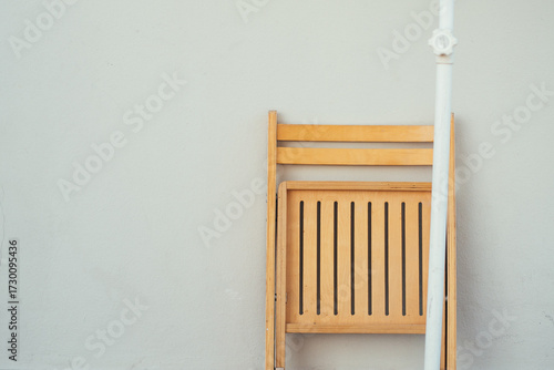 wooden chair in front of white wall