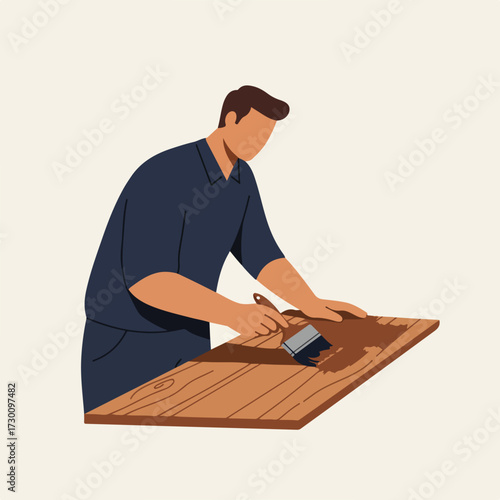 Man staining wood panel with brush, faceless, wearing dark shirt on beige background