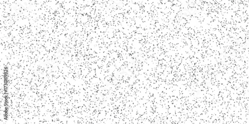 Dense monochromatic speckled texture background with a high concentration of small irregular geometric shapes in shades of grey on a white base