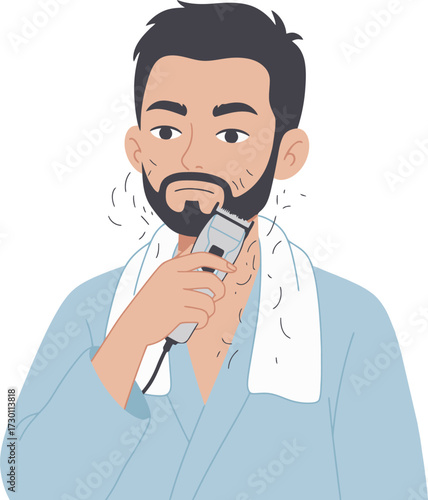 Man in robe trims his beard with an electric razor, towel around neck.