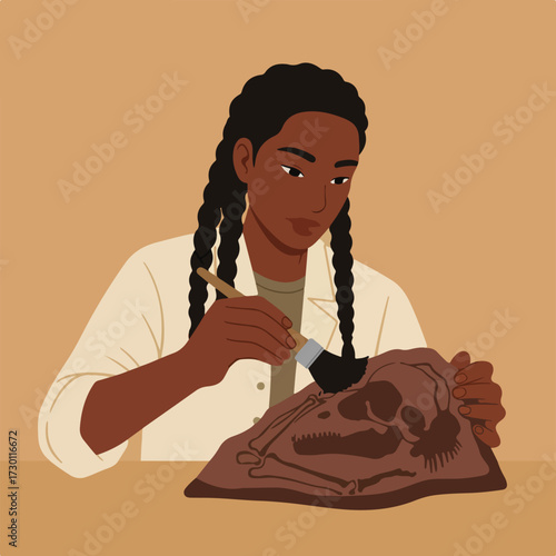 Woman carefully brushes earth away from fossilized primate skull and bones