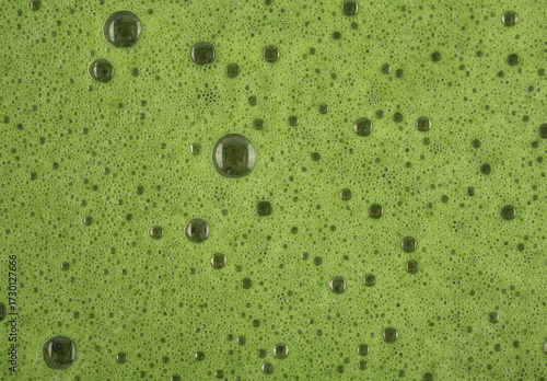 Matcha foam with bubbles close up.