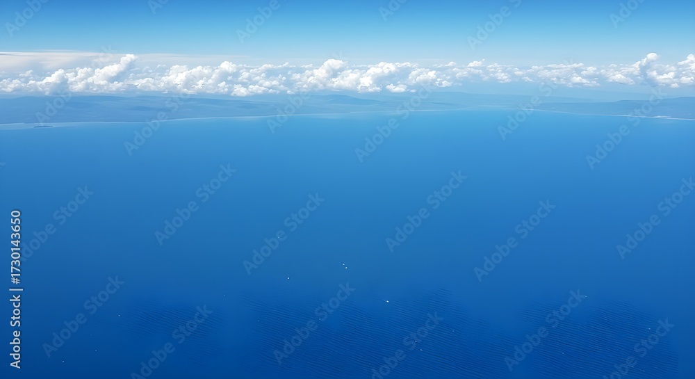 Obraz premium Tranquil seascape featuring calm ocean waves and vibrant blue sky at horizon line