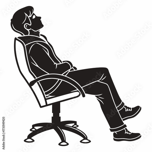 Silhouette of a young man in casual clothing relaxing in an office chair with his head tilted back and eyes closed in a moment of repose and contemplation
