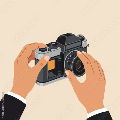 Hands holding an old camera, adjusting the lens, on a plain light brown background