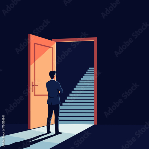 A person stands at the threshold of an open door looking at a staircase leading upwards in the dark.