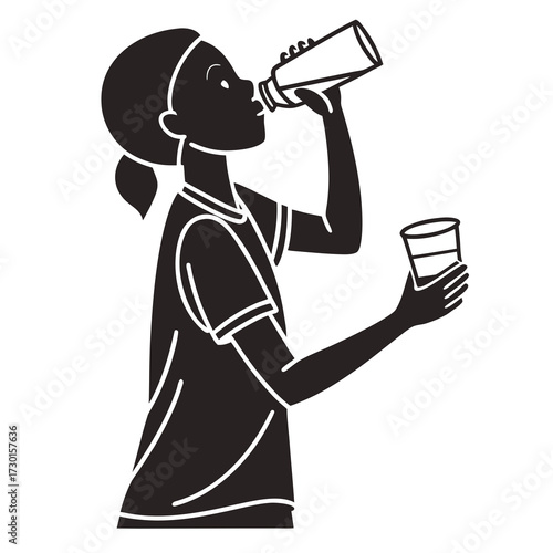 Silhouette of a young girl in athletic wear drinking from a water bottle and holding a glass of water during a break