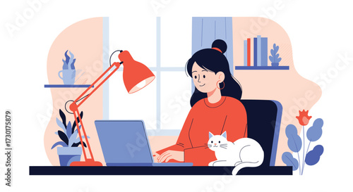 A woman works at a desk with a laptop and a cat beside her.