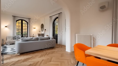 A bright and airy dining area with an open-plan layout and warm orange accents.