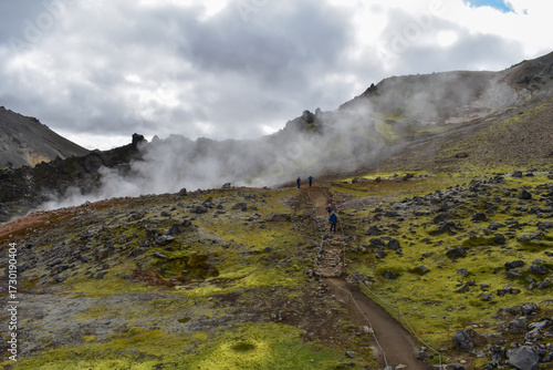 Smoke coming from a volcano, colorful mountains and rocks, landscape