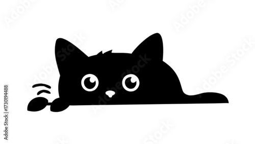A black cat peeking over a ledge with wide eyes and a playful paw reaching out in a curious manner