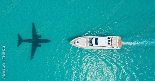 Aerial View of a Luxury Yacht with a Private Jet Shadow in Tropical Waters